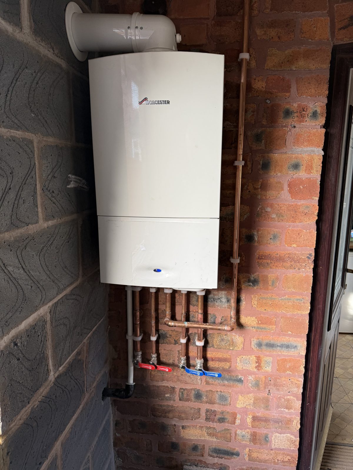 Worcester boiler installed on brick with neat copper pipework
